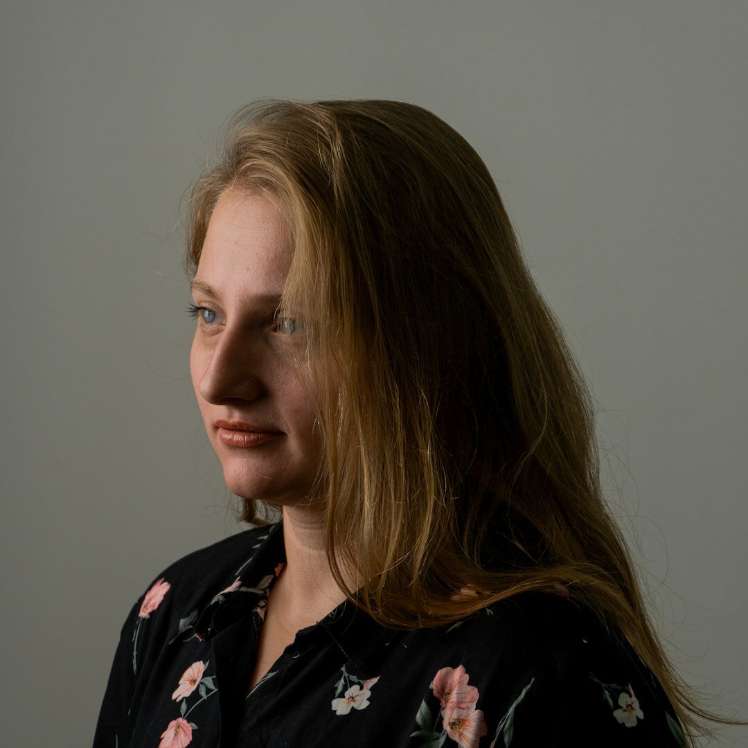 Studio portrait of a smiling young woman with short brown hair