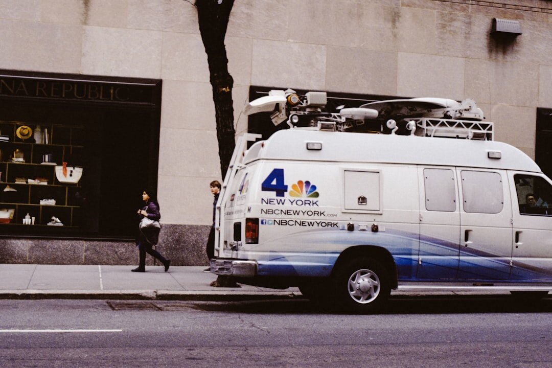 Broadcast satellite van parked near a live event