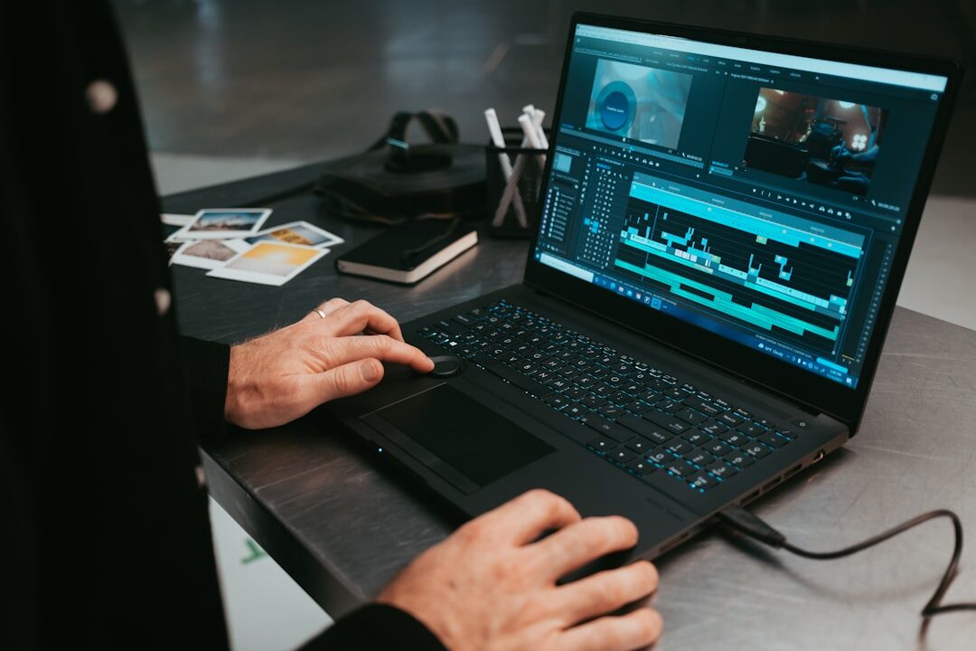 Person editing video footage on a laptop