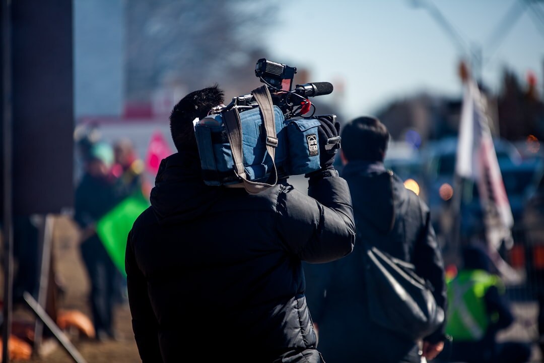 Camera crew filming a report outdoors in the city